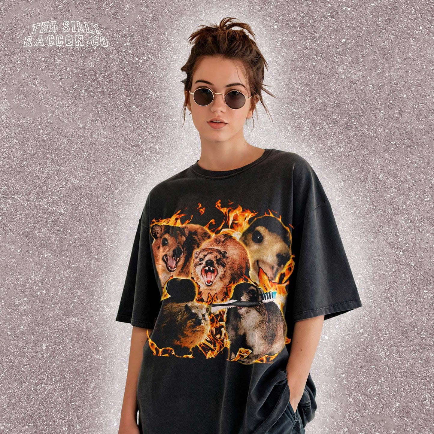 Funny animal t-shirt for men and women featuring a chaotic collage of screaming and intense rock hyrax rodents surrounded by flames. Printed on a vintage-wash black Comfort Colors shirt with a surreal, cursed meme style. Includes random elements like a toothbrush for added absurdity. Perfect for fans of weird humor, meme culture, and cursed animal designs. Great gift for chaotic friends, brothers, or unhinged meme lovers.