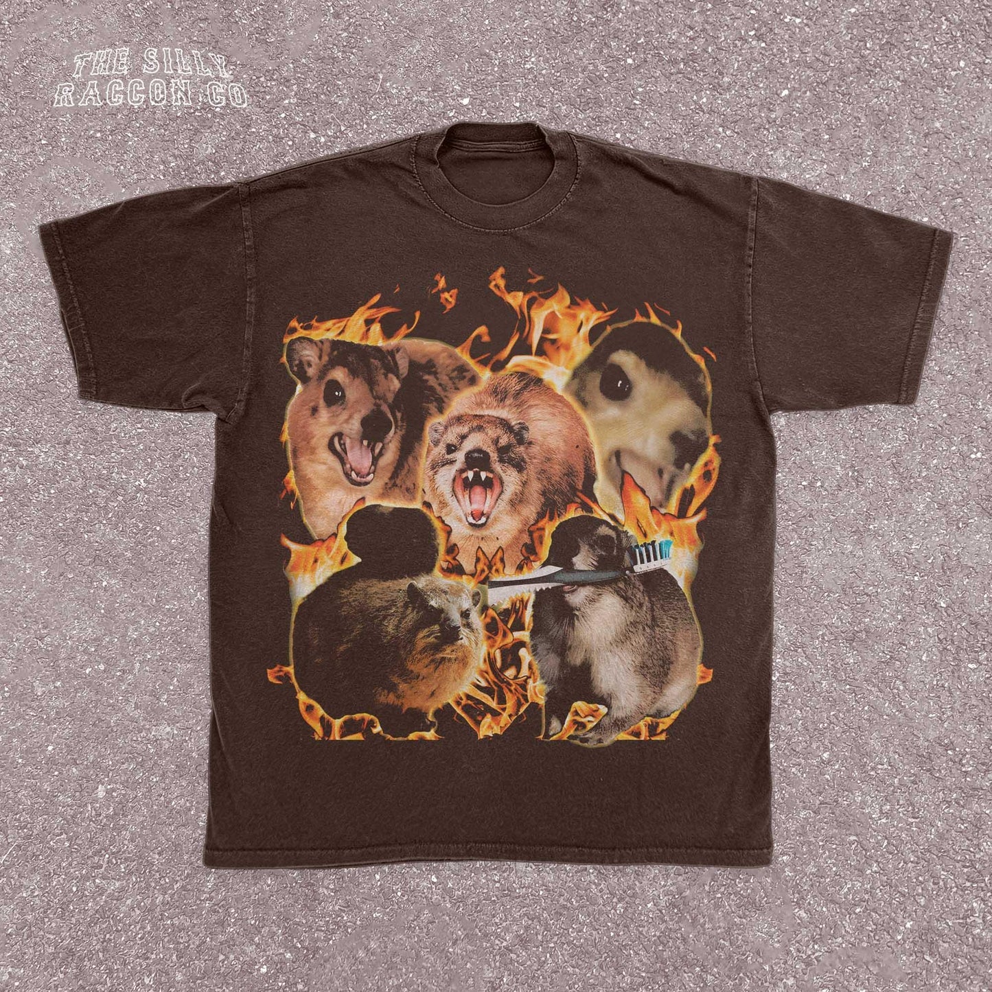 Funny animal t-shirt for men and women featuring a chaotic collage of screaming and intense rock hyrax rodents surrounded by flames. Printed on a vintage-wash black Comfort Colors shirt with a surreal, cursed meme style. Includes random elements like a toothbrush for added absurdity. Perfect for fans of weird humor, meme culture, and cursed animal designs. Great gift for chaotic friends, brothers, or unhinged meme lovers.