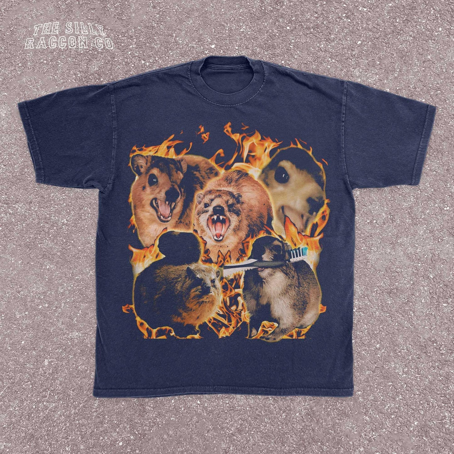 Funny animal t-shirt for men and women featuring a chaotic collage of screaming and intense rock hyrax rodents surrounded by flames. Printed on a vintage-wash black Comfort Colors shirt with a surreal, cursed meme style. Includes random elements like a toothbrush for added absurdity. Perfect for fans of weird humor, meme culture, and cursed animal designs. Great gift for chaotic friends, brothers, or unhinged meme lovers.