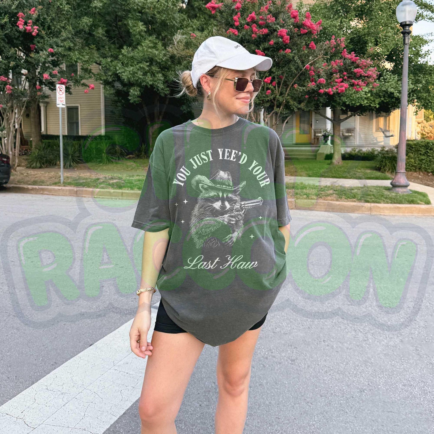Funny cowboy raccoon t-shirt featuring a vintage-style hand-drawn raccoon in a cowboy hat holding a revolver. This Western humor graphic tee is perfect for country lovers, rodeo fans, and meme enthusiasts. Designed for men and women who love Southern slang, Wild West culture, and outlaw aesthetics. Great for casual wear, cowboy-themed parties, or as a hilarious gift for raccoon lovers and Western humor fans.