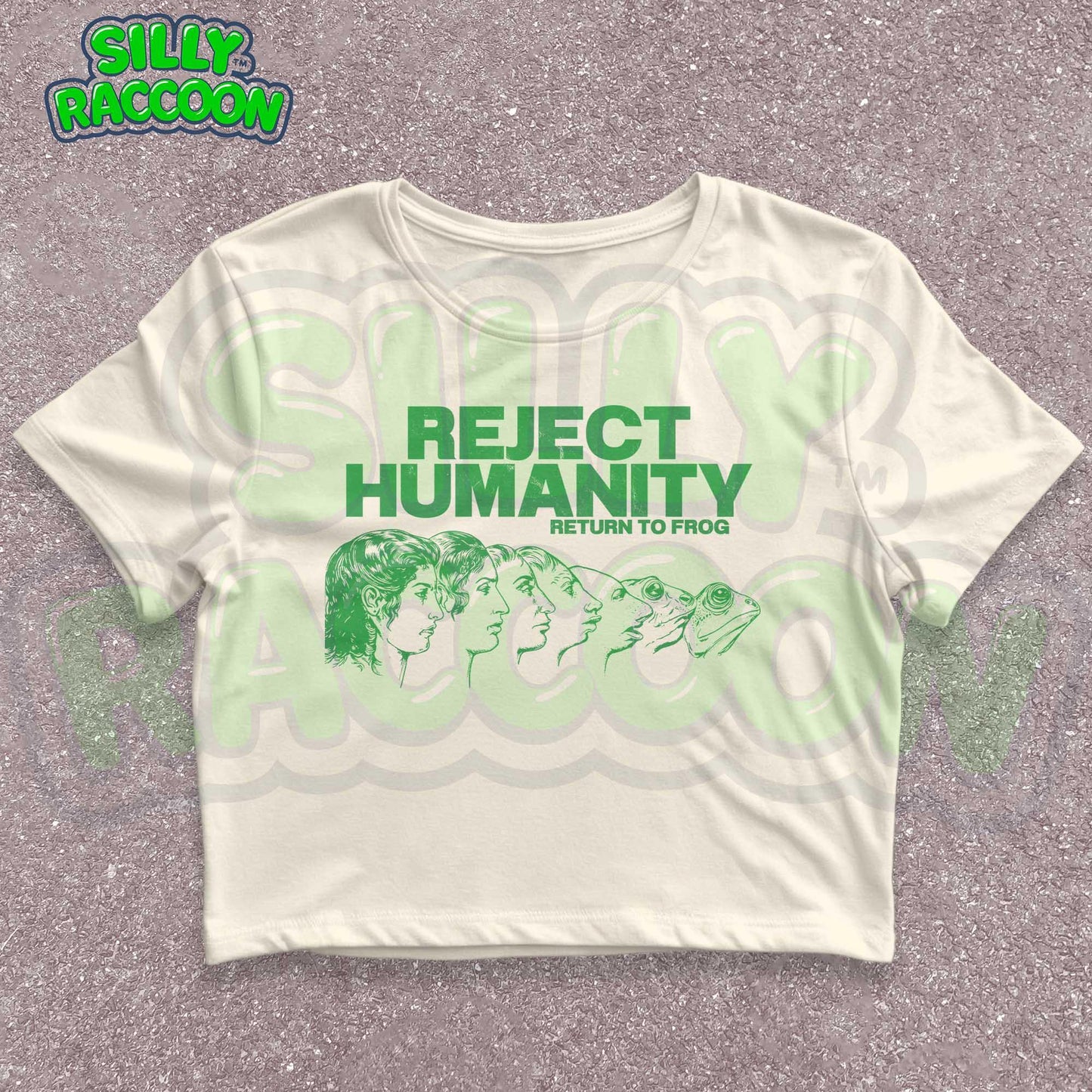 Young woman wearing a white Y2K baby tee, perfect for Gen Z fashion lovers and teens into alt clothing. The shirt features a green graphic print with the text "REJECT HUMANITY RETURN TO FROG" and an illustration showing human faces morphing into frogs. This funny meme shirt taps into internet culture and weirdcore aesthetic. It's a great sarcastic gift for anti-social friends or any frog lover. Ideal casual wear top, this graphic tee suits everyday outfits or alternative style look