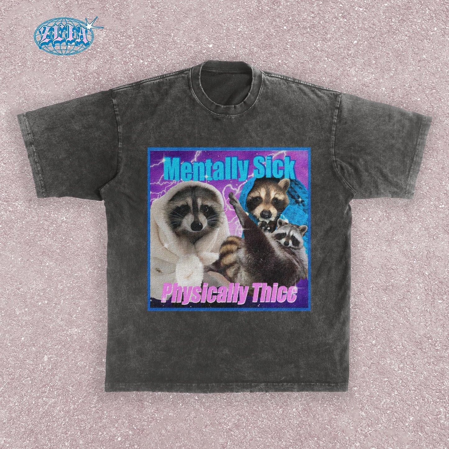 A dark grey t-shirt featuring three raccoons in a y2k aesthetic frame with blue and purple lightning effects, text reads Mentally Sick Physically Thicc in retro style typography