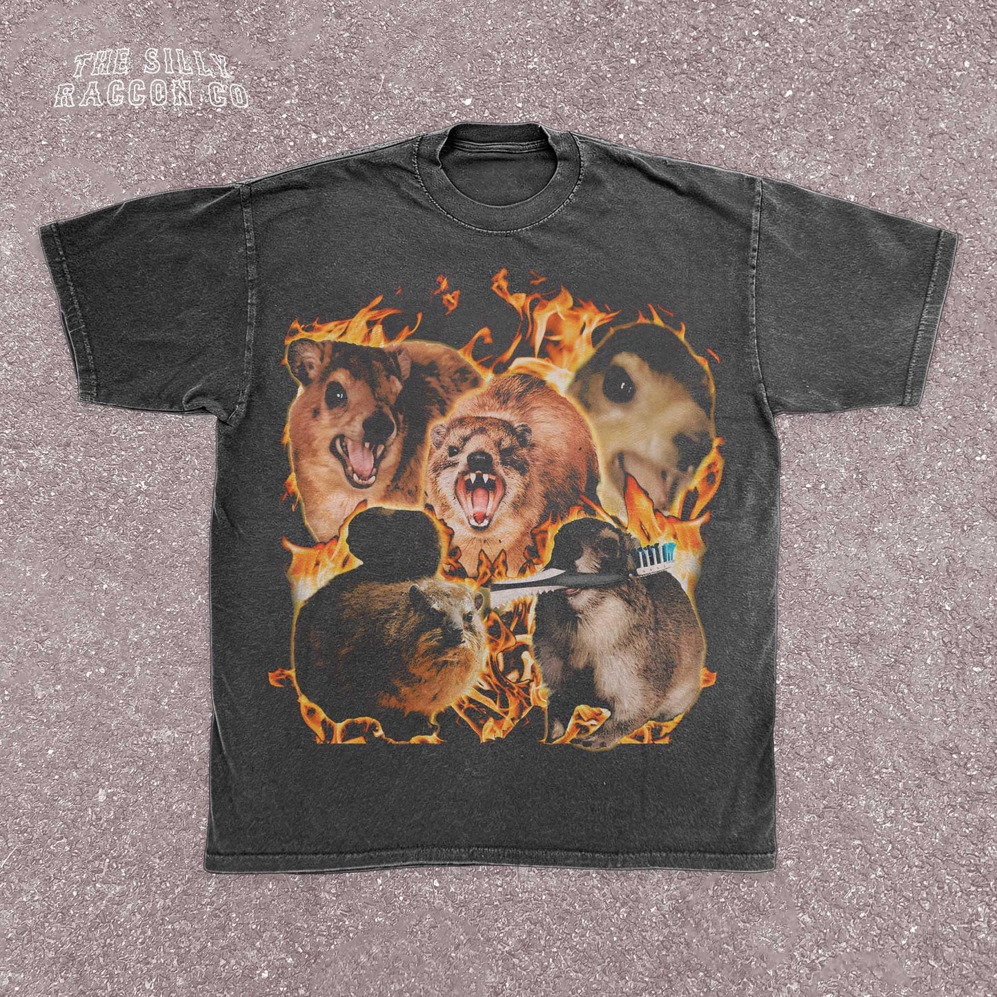 Funny animal t-shirt for men and women featuring a chaotic collage of screaming and intense rock hyrax rodents surrounded by flames. Printed on a vintage-wash black Comfort Colors shirt with a surreal, cursed meme style. Includes random elements like a toothbrush for added absurdity. Perfect for fans of weird humor, meme culture, and cursed animal designs. Great gift for chaotic friends, brothers, or unhinged meme lovers.