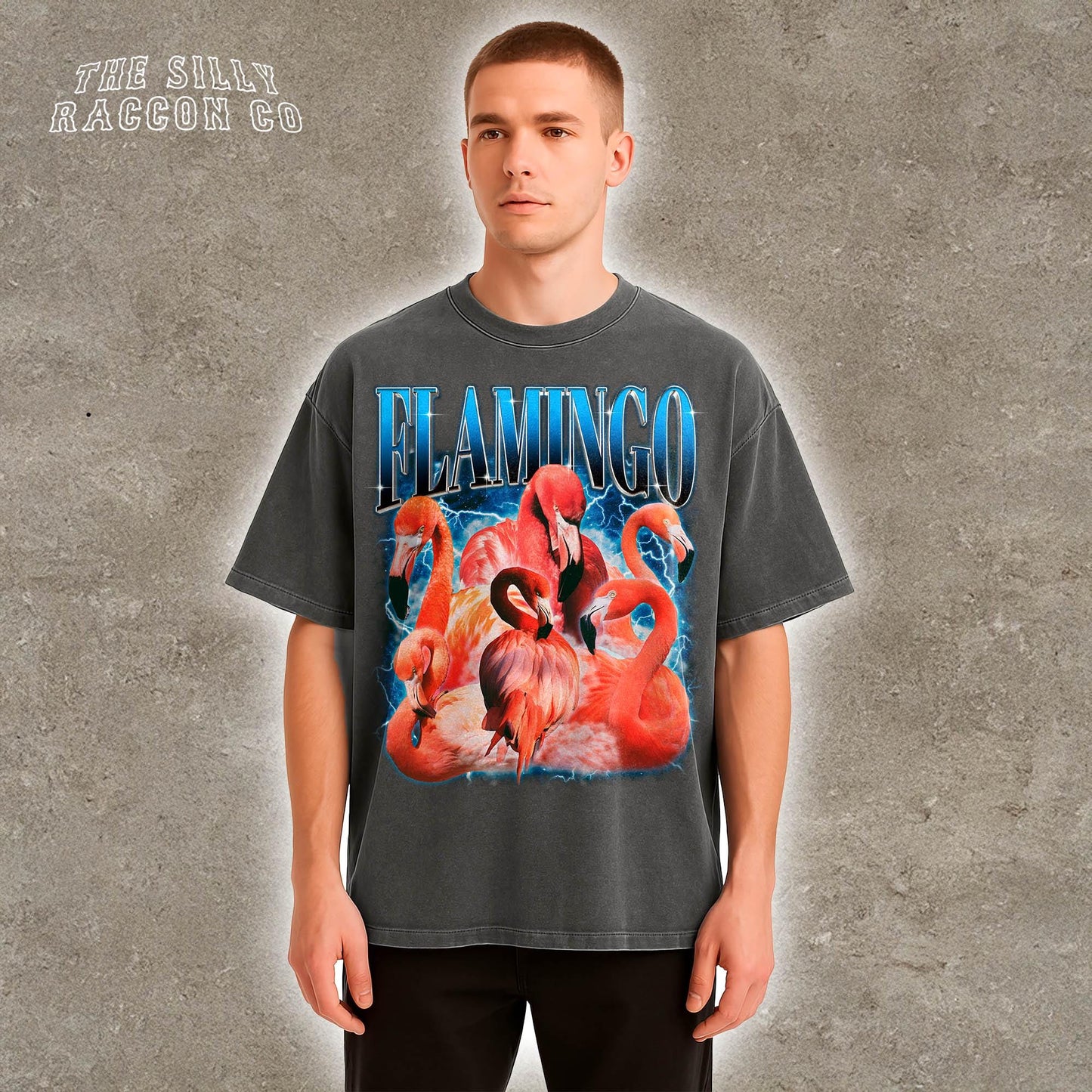 A man wearing a grey t-shirt with a graphic design of flamingos.