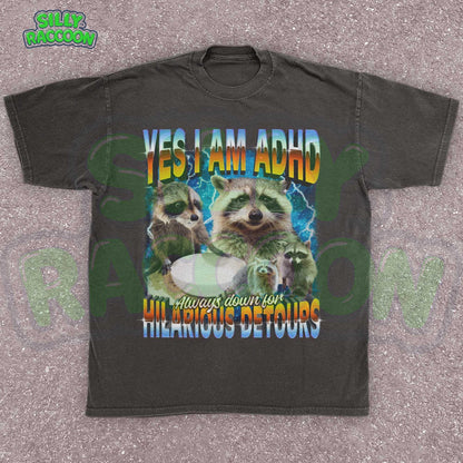 Funny vintage-style ADHD awareness shirt for adults featuring humorous raccoon meme design. Text reads “YES I AM ADHD - Always down for HILARIOUS DETOURS” in vibrant retro gradient colors against cosmic starry background. Graphic includes multiple playful raccoons, perfect for neurodiverse adults, meme lovers, and humorous animal enthusiasts. Ideal gift tee for birthdays, ADHD pride events, or casual everyday wear embracing spontaneous personalities.