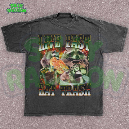 Funny raccoon graphic shirt for men and women featuring chaotic dumpster raccoons in a vintage meme collage style. Bold distressed text reads &quot;Live Fast Eat Trash&quot; over retro raccoons eating pizza and digging in garbage. Designed for meme lovers, unhinged humor fans, and raccoon-core enthusiasts. Perfect for birthdays, Gen Z humor gifts, or streetwear animal aesthetics. Makes a hilarious gift for trash panda lovers or quirky friends.