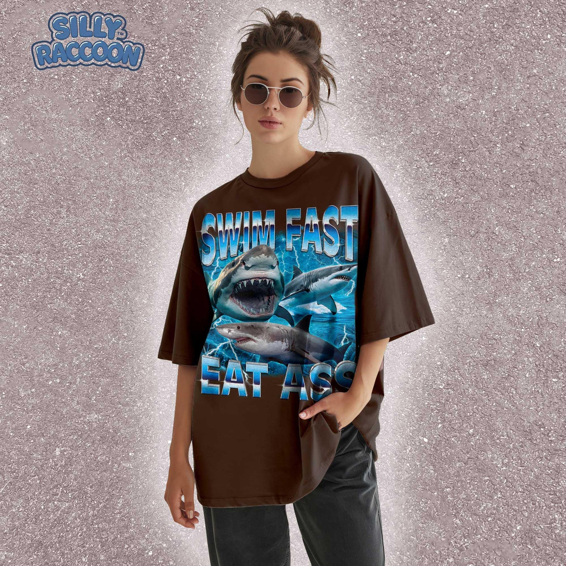 Funny adult humor graphic tee featuring three fierce sharks swimming aggressively with the edgy phrase &quot;Swim Fast Eat Ass.&quot; Vibrant vintage-style design with bold blue letters and ocean wave graphics. Perfect meme culture shirt for young adults, shark lovers, sarcastic friends, or edgy trendsetters. Ideal casual tee for Shark Week, beach trips, parties, or humorous gifts. Provocative yet playful, this shirt makes a bold style statement.