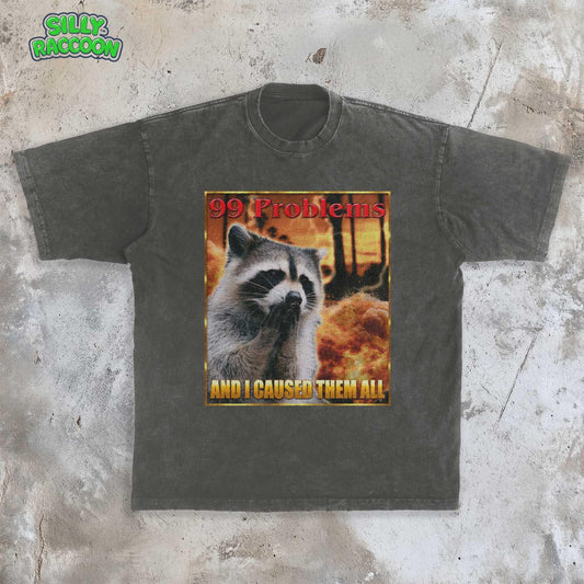 This Comfort Colors t-shirt features a funny raccoon meme design perfect for women and men who love weird, sarcastic humor. The retro-style graphic on this unisex tee shows a raccoon looking guilty with the text &quot;99 Problems AND I CAUSED THEM ALL,&quot; ideal for casual wear or as a gag gift for a friend who appreciates ironic, unhinged shirts and possum-themed humor.