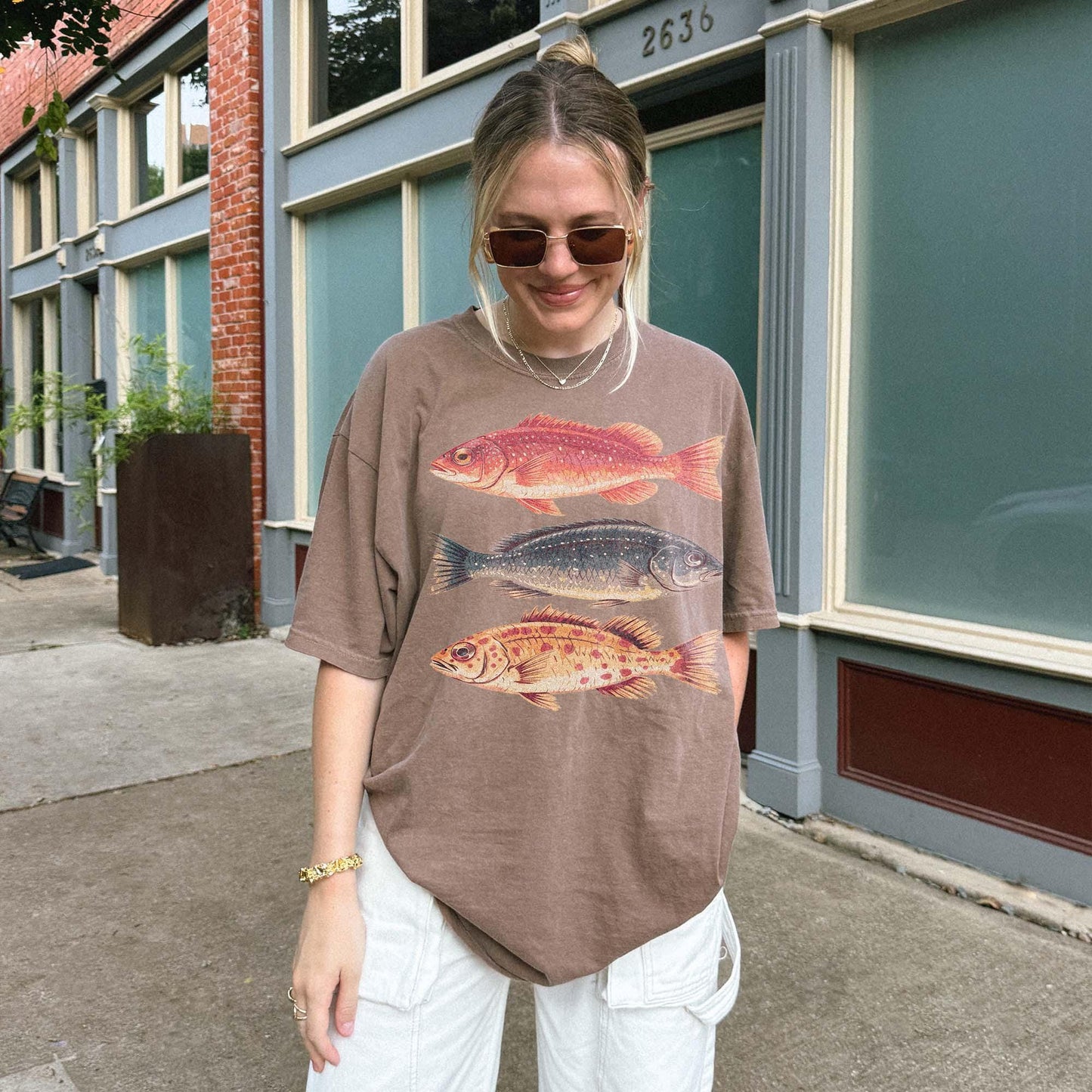 Vintage fish shirt for men and women featuring three illustrated fish in retro colors on a natural Comfort Colors tee. Perfect for outdoorsy types, ocean lovers, anglers, and marine biology fans. This nature-themed graphic t-shirt combines vintage style with beachy summer vibes. A great gift for fishermen, Father&#39;s Day, or anyone into fishing, sea life, or the outdoors. Classic fit with artistic nature illustrations.