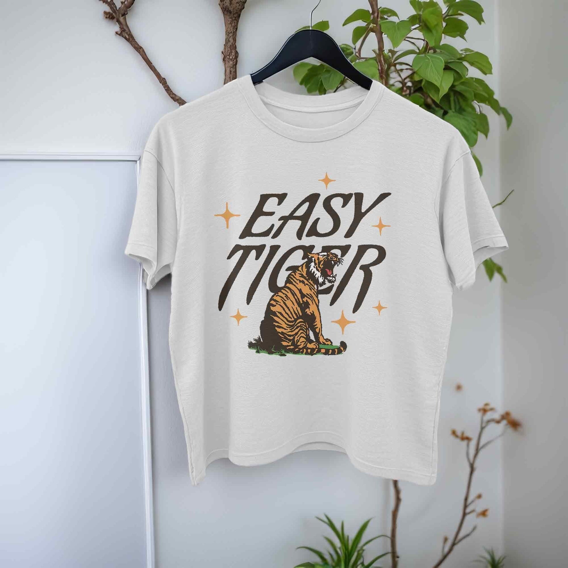 White crop top t-shirt featuring a playful retro-style graphic of a tiger with the text Easy Tiger.