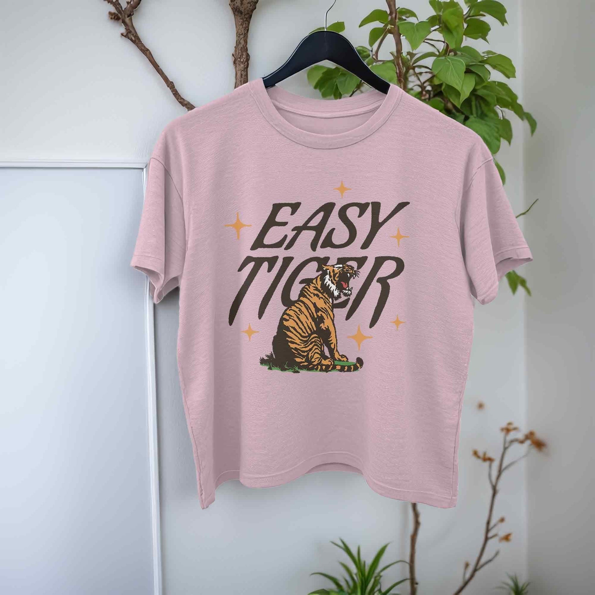 light pink crop top t-shirt featuring a playful retro-style graphic of a tiger with the text Easy Tiger.