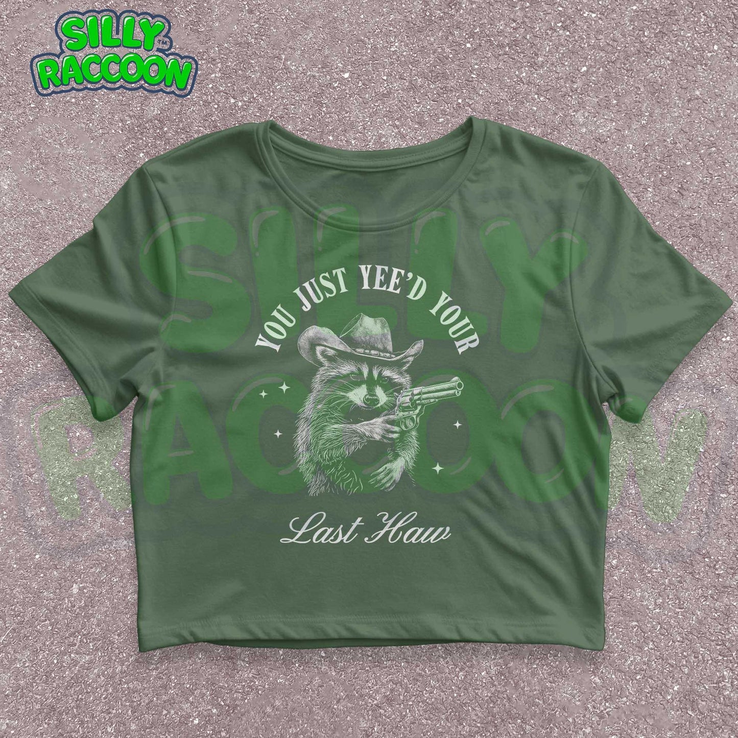 Funny western crop top for women featuring a detailed sketch of a raccoon wearing a cowboy hat and aiming a pistol. The text &quot;You Just Yee&#39;d Your Last Haw&quot; surrounds the raccoon graphic. This humorous graphic tee blends country and meme culture, perfect for young adults and women who love sarcastic animal shirts. Ideal gift for country girls, raccoon lovers, or anyone who enjoys funny southern sayings and western meme apparel.