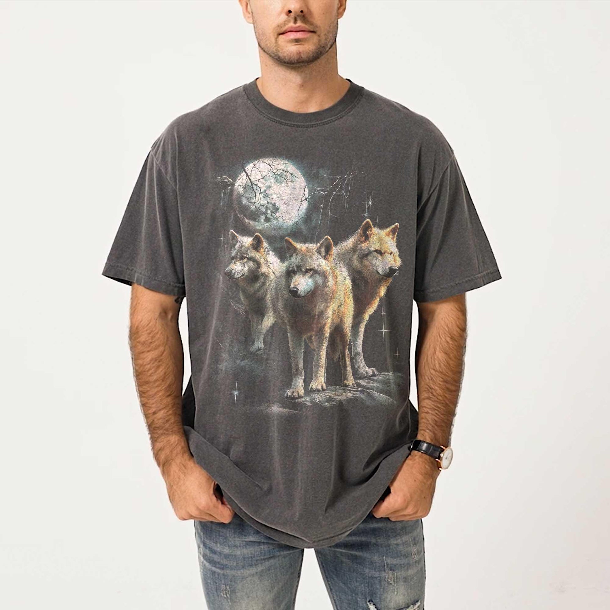 Vintage washed black graphic T-shirt for men, women, and unisex, featuring three realistic wolves standing proudly under a glowing full moon in a mystical forest setting. Retro style reminiscent of 90s nostalgia, perfect for animal lovers and humorously ironic aesthetics. Ideal funny gift for men, dads, brothers, or friends who appreciate spirit animal themes and quirky fashion. Soft, comfy fit makes this tee a standout piece for everyday casual wear or special occasions.
