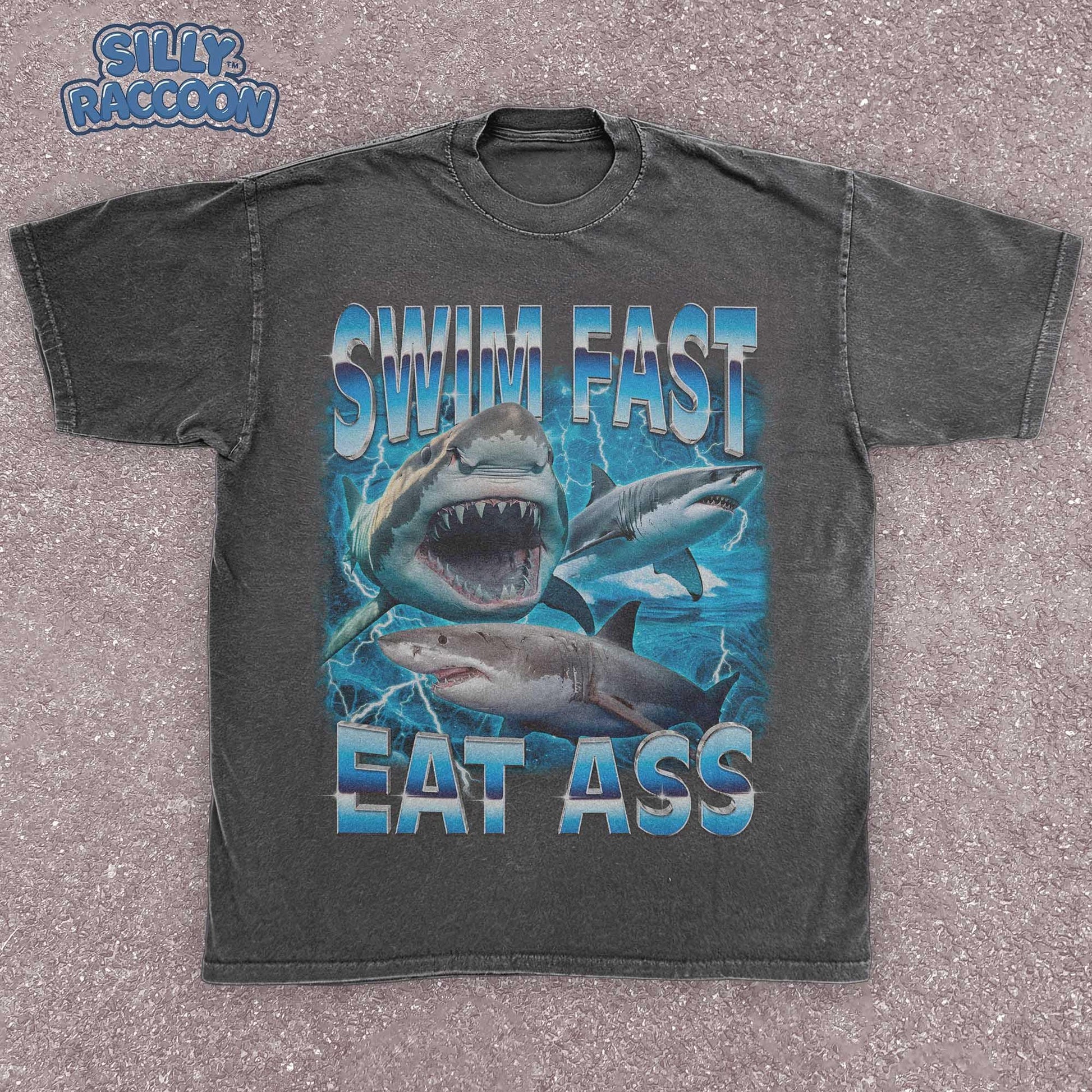 Funny adult humor graphic tee featuring three fierce sharks swimming aggressively with the edgy phrase &quot;Swim Fast Eat Ass.&quot; Vibrant vintage-style design with bold blue letters and ocean wave graphics. Perfect meme culture shirt for young adults, shark lovers, sarcastic friends, or edgy trendsetters. Ideal casual tee for Shark Week, beach trips, parties, or humorous gifts. Provocative yet playful, this shirt makes a bold style statement.