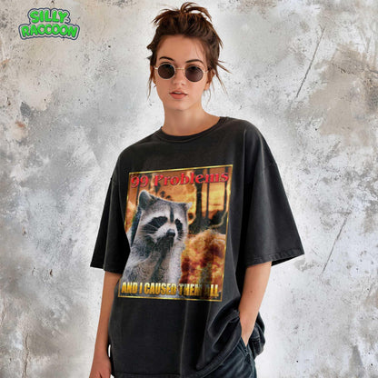 This Comfort Colors t-shirt features a funny raccoon meme design perfect for women and men who love weird, sarcastic humor. The retro-style graphic on this unisex tee shows a raccoon looking guilty with the text &quot;99 Problems AND I CAUSED THEM ALL,&quot; ideal for casual wear or as a gag gift for a friend who appreciates ironic, unhinged shirts and possum-themed humor.