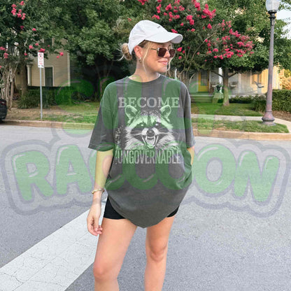 Vintage grunge dark grey t-shirt featuring an angry raccoon with the slogan Become Ungovernable. Perfect for fans of rebellious wildlife and sarcastic humor.