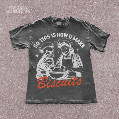 Funny cat t-shirt for men and women featuring a vintage-style illustration of a woman and a cat &quot;making biscuits&quot; together in a mixing bowl. The cat wears a chef hat, humorously mimicking the kneading behavior cats are known for. Retro colors and design give it a nostalgic feel. Great for cat lovers, pet parents, and fans of funny animal shirts. Makes a perfect gift for cat moms, dads, or kitchen humor enthusiasts.
