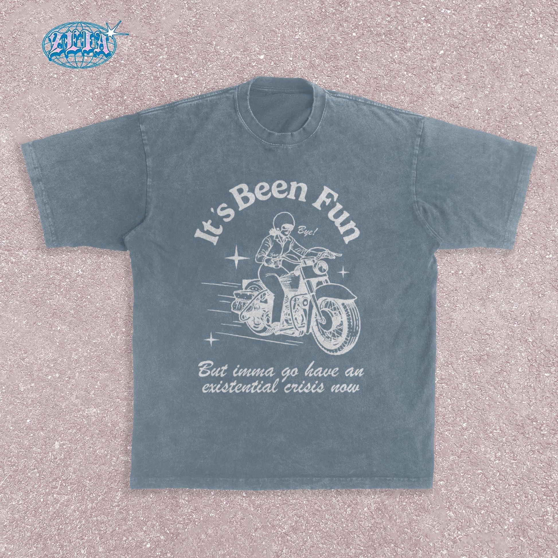 Retro style motorcycle blue jean t-shirt featuring vintage White illustration of classic motorcycle with rider, stars and speed lines, combined with ironic existential crisis text in curved lettering, perfect for bikers.