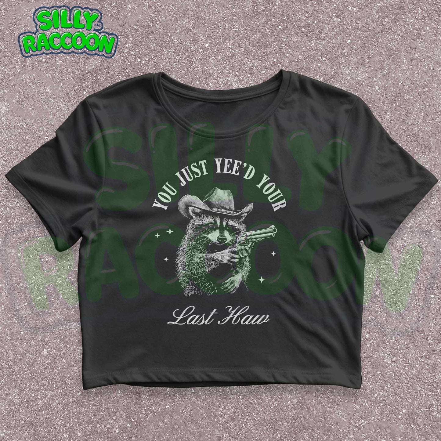 Funny western crop top for women featuring a detailed sketch of a raccoon wearing a cowboy hat and aiming a pistol. The text &quot;You Just Yee&#39;d Your Last Haw&quot; surrounds the raccoon graphic. This humorous graphic tee blends country and meme culture, perfect for young adults and women who love sarcastic animal shirts. Ideal gift for country girls, raccoon lovers, or anyone who enjoys funny southern sayings and western meme apparel.