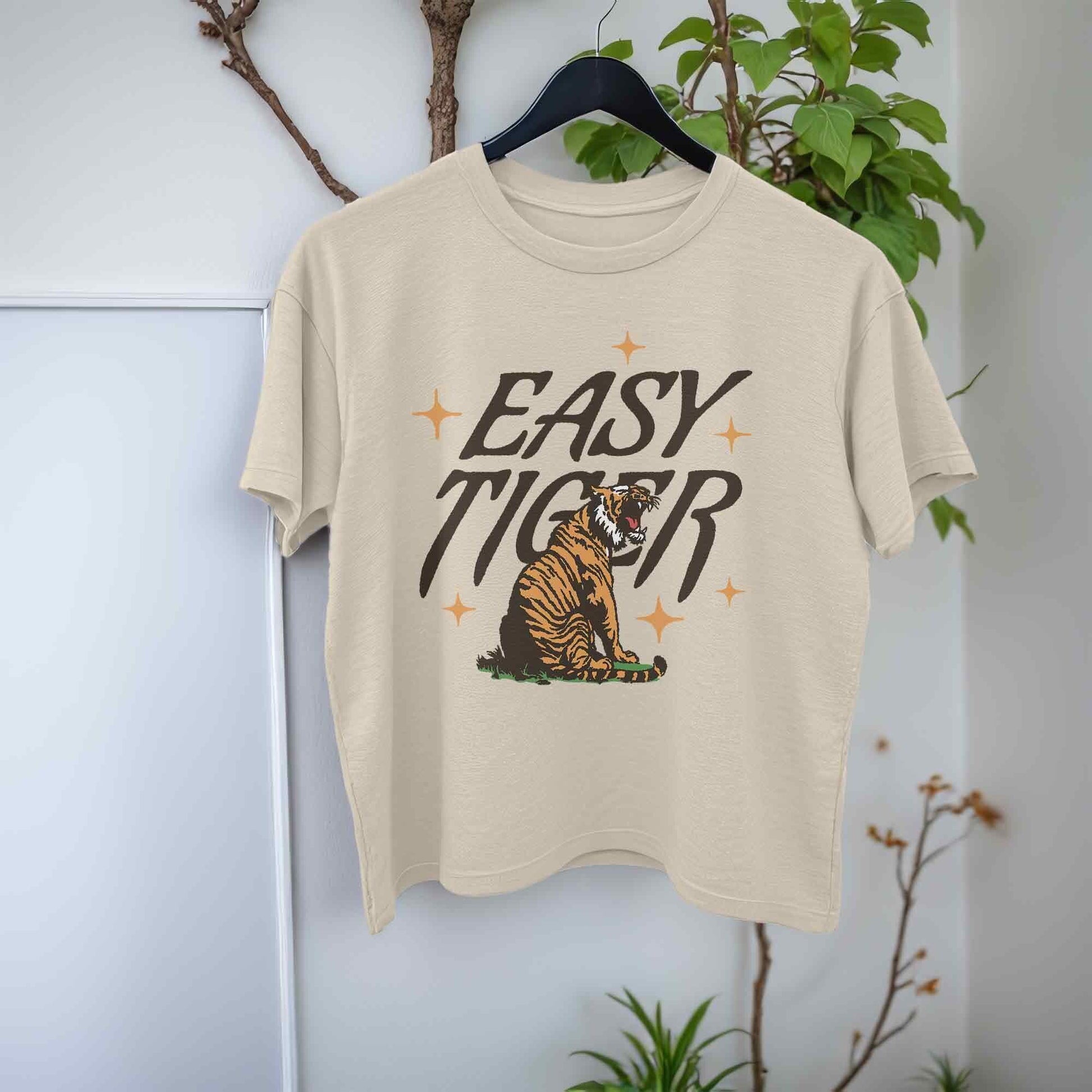beige crop top t-shirt featuring a playful retro-style graphic of a tiger with the text Easy Tiger.
