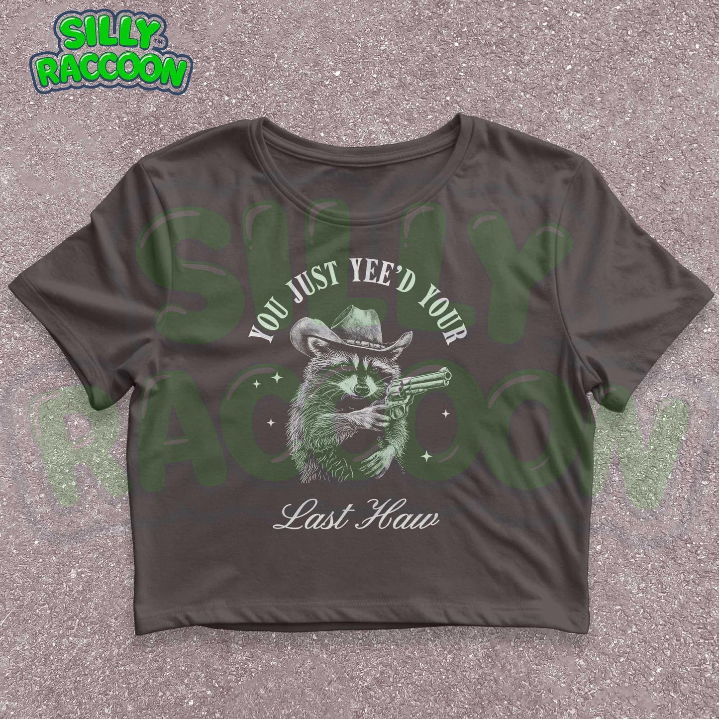 Funny western crop top for women featuring a detailed sketch of a raccoon wearing a cowboy hat and aiming a pistol. The text &quot;You Just Yee&#39;d Your Last Haw&quot; surrounds the raccoon graphic. This humorous graphic tee blends country and meme culture, perfect for young adults and women who love sarcastic animal shirts. Ideal gift for country girls, raccoon lovers, or anyone who enjoys funny southern sayings and western meme apparel.