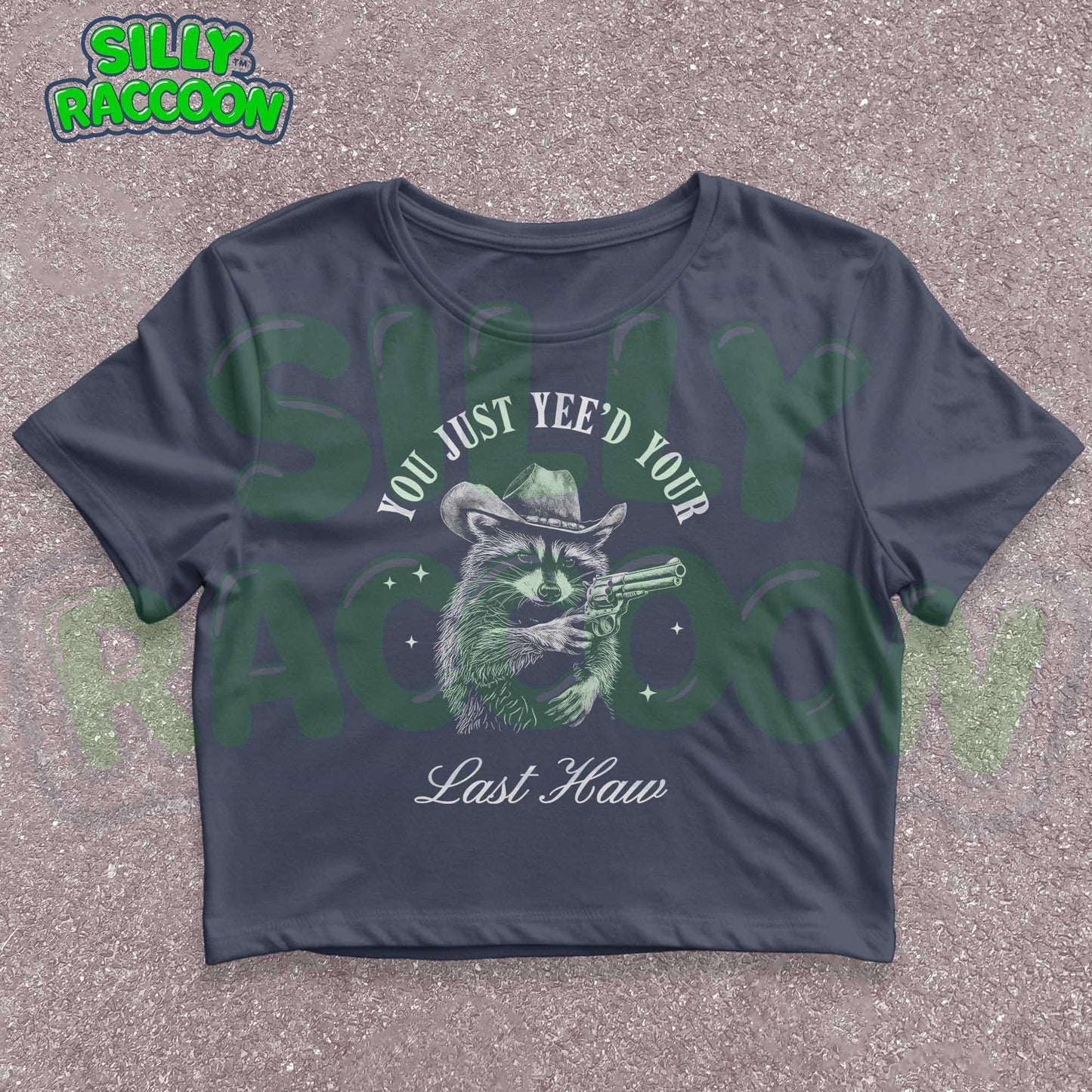 Funny western crop top for women featuring a detailed sketch of a raccoon wearing a cowboy hat and aiming a pistol. The text &quot;You Just Yee&#39;d Your Last Haw&quot; surrounds the raccoon graphic. This humorous graphic tee blends country and meme culture, perfect for young adults and women who love sarcastic animal shirts. Ideal gift for country girls, raccoon lovers, or anyone who enjoys funny southern sayings and western meme apparel.