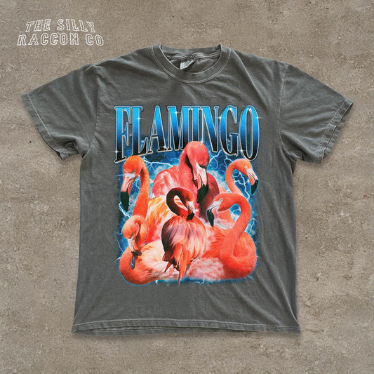 A gray t-shirt with a graphic design featuring a group of flamingos in a stylized, colorful style.
